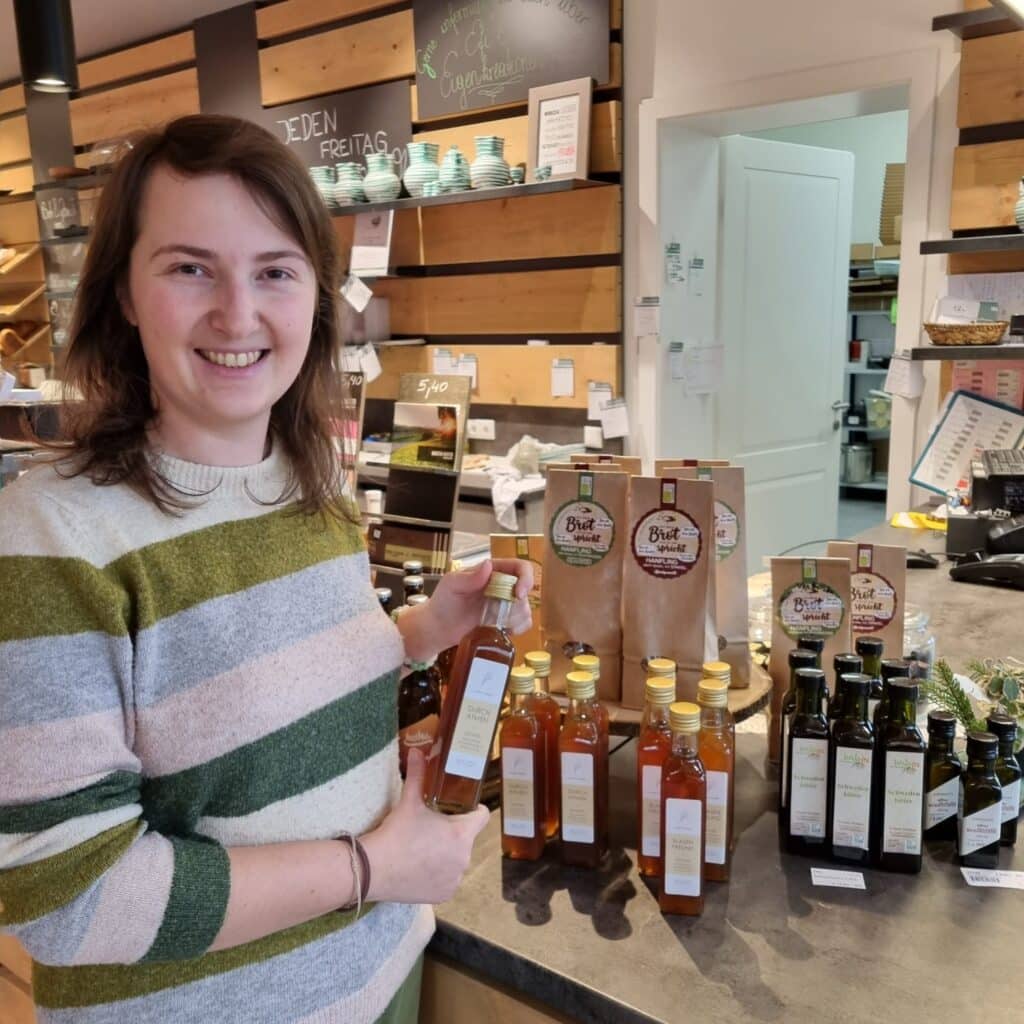 a woman holding bottles of oxymel